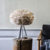 light brown goose feather lampshade styled on a modern black tripod base - base also available in white