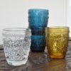 coloured glass tumblers in blue, amber, clear and green with decorative pressed design