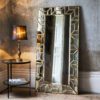 large all glass floor standing dressing mirror with a geometric mosaic frame with gold edging