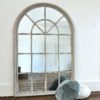 large wooden arched window mirror with a distressed grey painted finish