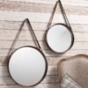 set of two industrial style round hanging mirrors with leather straps