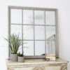 square window mirror with 12 panes finished in a wooden frame with a distressed light grey painted finish
