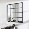 large metal framed square window mirror with a distressed black painted finish