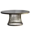 round coffee table with a lightly distressed brass metal cage design base topped with a smoked glass