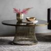 round side table with a lightly distressed brass metal cage design base topped with a smoked glass