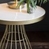 round side table with a champagne gold metal cage design base topped with solid white marble