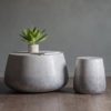 circular smooth rounded coffee table or side table with a concrete effect silver-grey ombre finish