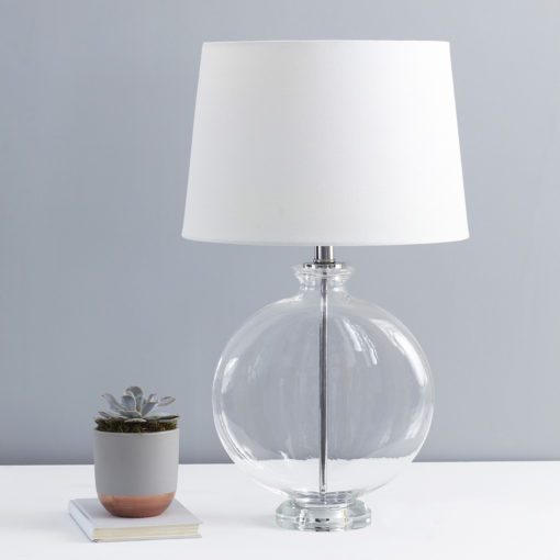 round thin glass table lamp base with nickel inner pole and collar topped with a white tapered lampshade