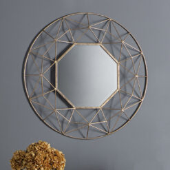 decorative round wall mirror with a wide geometric wire metal frame finished in gold leaf