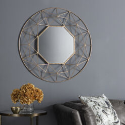 decorative round wall mirror with a wide geometric wire metal frame finished in gold leaf