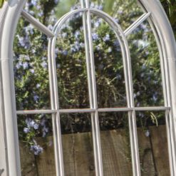 a large metal arched window mirror finished in a light grey paint which has been lightly distressed - weatherproof for outdoor living