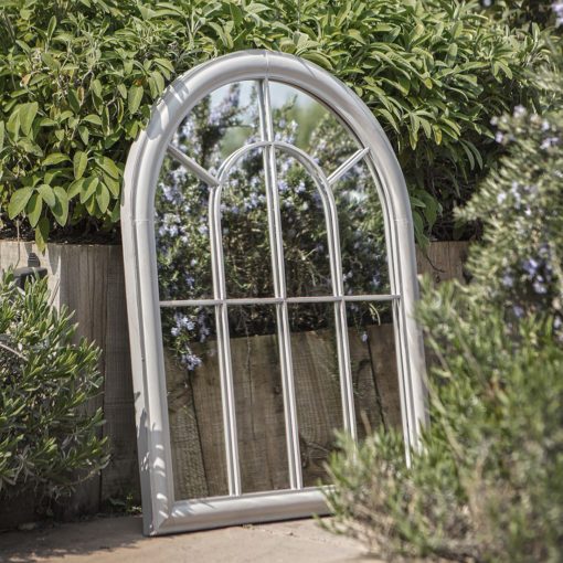 a large metal arched window mirror finished in a light grey paint which has been lightly distressed - weatherproof for outdoor living