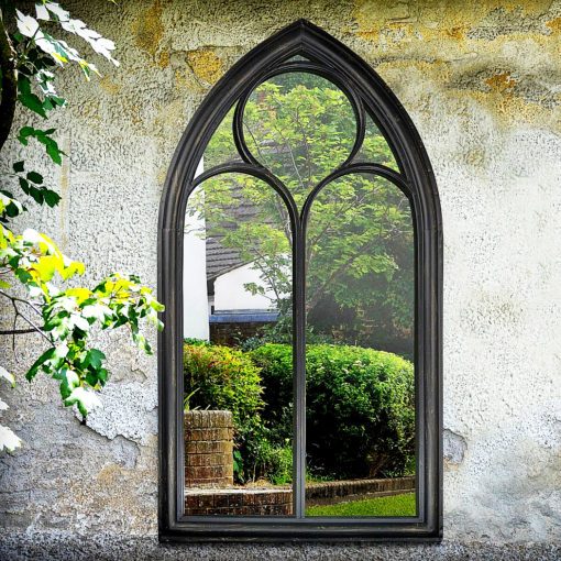 outdoor gothic arched garden mirror with a metal frame finished in a distressed black