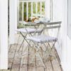 metal bistro garden set comprising of small round table and two chairs with a weatherproof clay painted finish