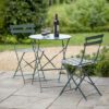 green outdoor metal bistro set comprising of small table and two foldable chairs
