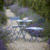 blue outdoor metal bistro set comprising of small table and two foldable chairs