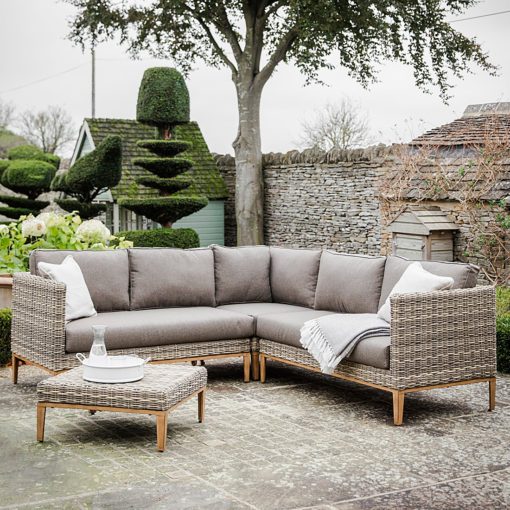 outdoor weatherproof rattan corner sofa set on a contemporary aluminum base with wood effect legs, brown showerproof cushions and complete with matching coffee table