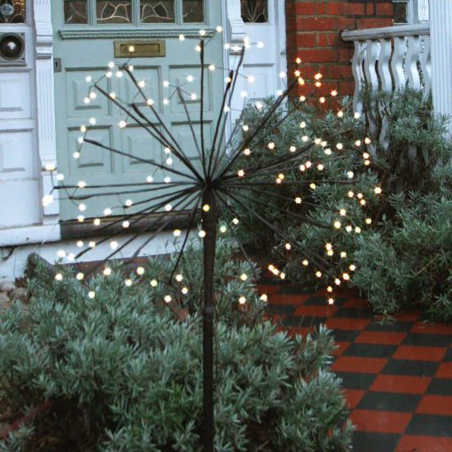 large solar powered starburst light on a pole in black