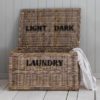 large rectangular rattan laundry chest with lift up lid and light and dark compartments