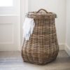 large round pear shaped rattan laundry basket with lid and rope handle detail