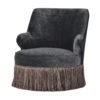 round tub armchair upholstered in a dark grey velvet and finished with a long fringing around the base