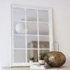 large wooden framed rectangle window mirror with a distressed white painted finish