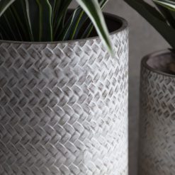 round platerns with a white textured planter which sits on a wooden stand with four legs available in small or large