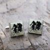 hand-enamelled square cufflinks made from brass with a nickel coating with the silhouette of racing cyclists