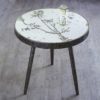 round side table with tripod legs and a mirrored top with a cow parsley bronze etched design