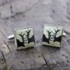 hand-enamelled square cufflinks made from brass with a nickel coating with the silhouette of black rutting stags