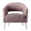 armchair upholstered in a blush pink velvet with four gold stem legs