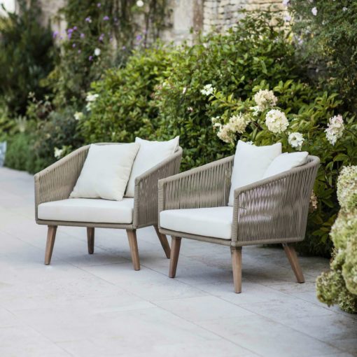 set of two acacia wood tub armchairs with a polyrope frame complete with ivory seat pads and cushions