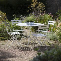 chalky-white painted metal bistro dining set comprising round table and four folding chairs