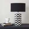 ceramic table lamp with a monochrome zig zag design completed with a black cotton lampshade
