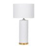 white ceramic column table lamp with a gold metal base and completed with a white cotton drum lampshade