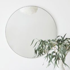 large cicular wall mirror edge in a silver leaf metal band