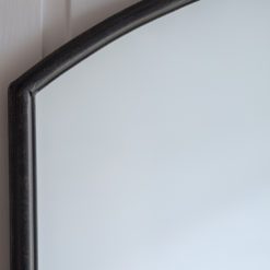 oversized large floor standing window wall mirror with a curved top and black industrial metal frame