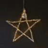 hanging christmas star decoration made of branches tied together to form a star with warm white led lights wrapped around