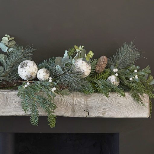 faux pine fir christmas garland decorated with rustic white baubles, berries, pine cones and faux eucalyptus