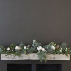 rustic Scandi inspired faux pine Christmas garland decorated with rustic white baubles, berries, pine cones and faux eucalyptus