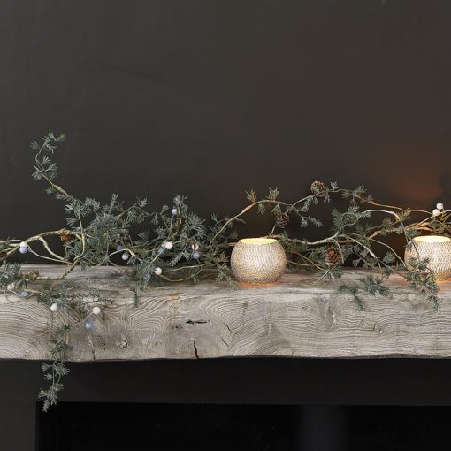 rustic faux fir Christmas garland adorned with white and pale blue berries, pine cones and dusting of glitter