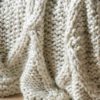 loose knit cream chunky cable knit throw with diamond design