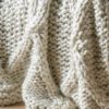 loose knit cream chunky cable knit throw with diamond design
