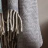 light grey and cream pure wool herringbone throw with cream braided fringe