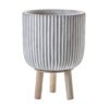 round concrete planter with a grey and white ribbed design on a pale wooden three leg base