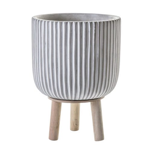 round concrete planter with a grey and white ribbed design on a pale wooden three leg base