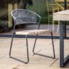 set of two outdoor dining chairs with a solid teak seat and contemporary rope back