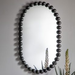 curved pill shaped wall mirror with a black metal bobble frame