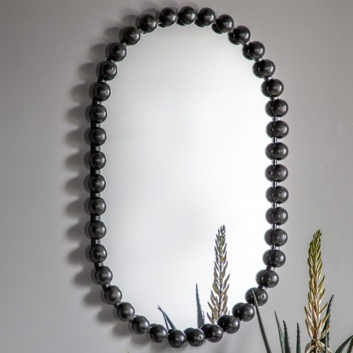 curved pill shaped wall mirror with a black metal bobble frame