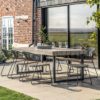 chunky industrial style outdoor large rectangular dining table with teak blocks and two iron square leg frames